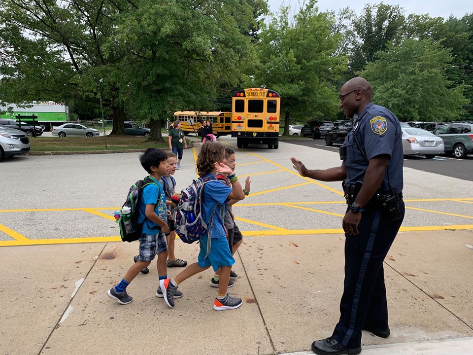 Abington Police officer participating in a high-five Friday initiative